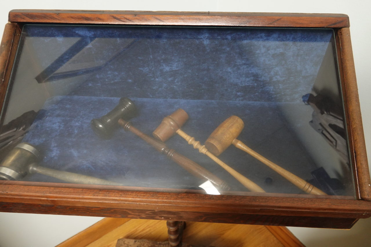 Gavels preserved in a glass display case