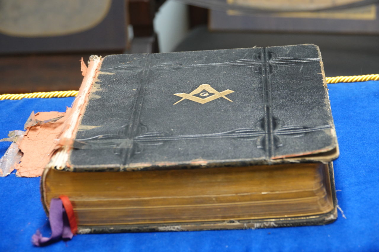 Worn Bible with a gold Masonic emblem on its cover